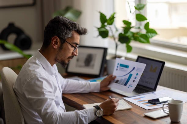 businessman working on financial report of corporate operations, balance
